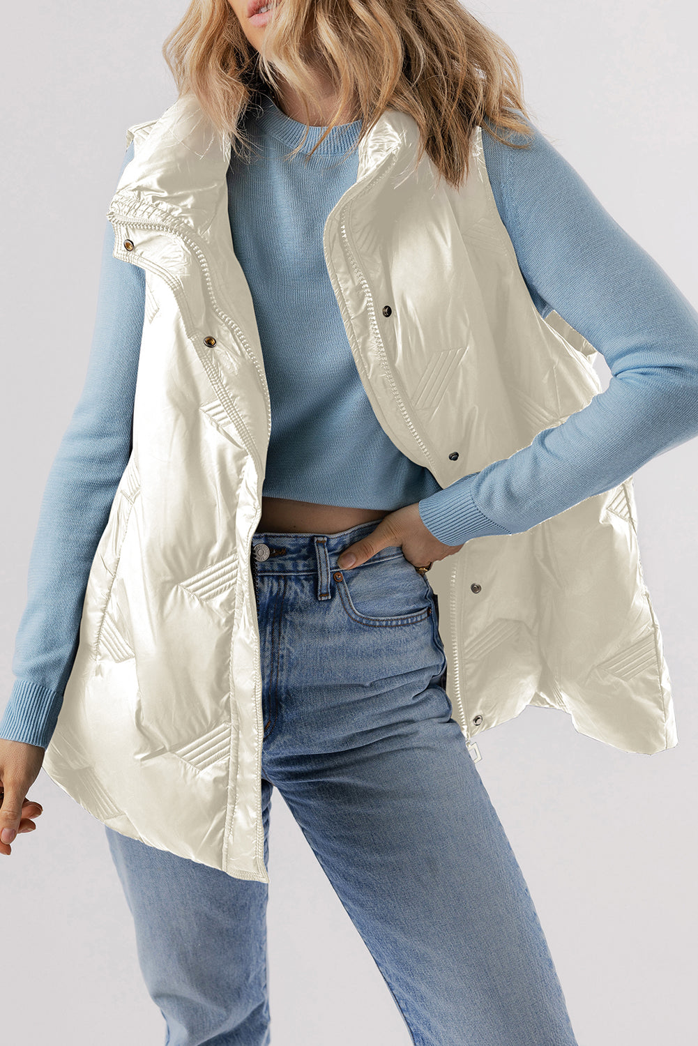 Model wearing white quilted high neck zip up jacket vest