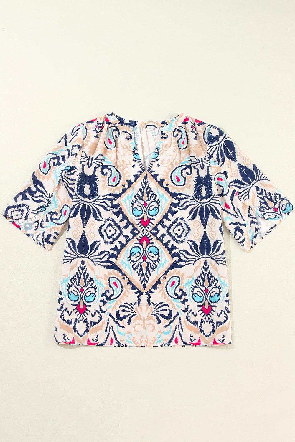 White abstract printed blouse laid flat, front