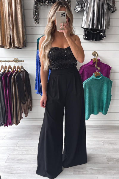 Black sequin tube top jumpsuit displayed in store