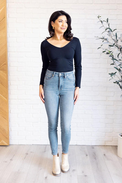 Model in black top and Justine high rise skinny jeans