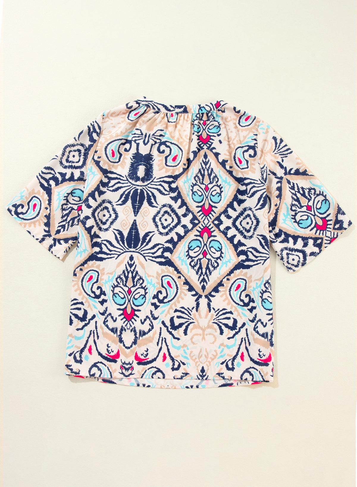 White abstract printed blouse laid flat, back