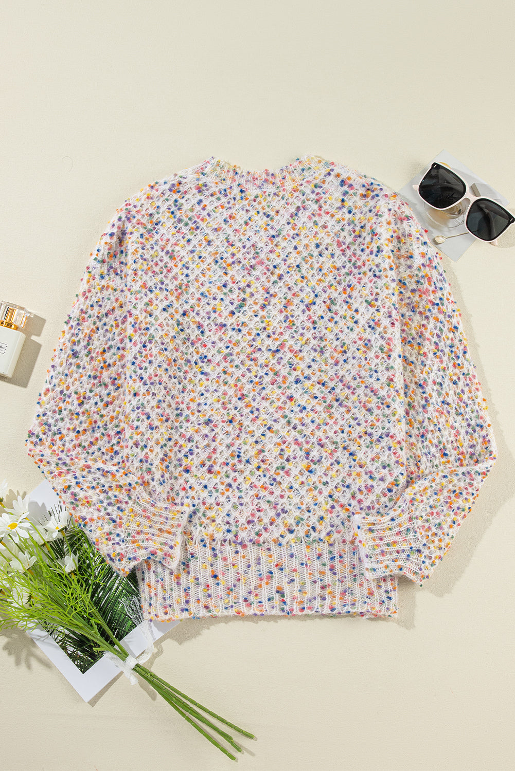 Back flat lay of white confetti knit popcorn sweater