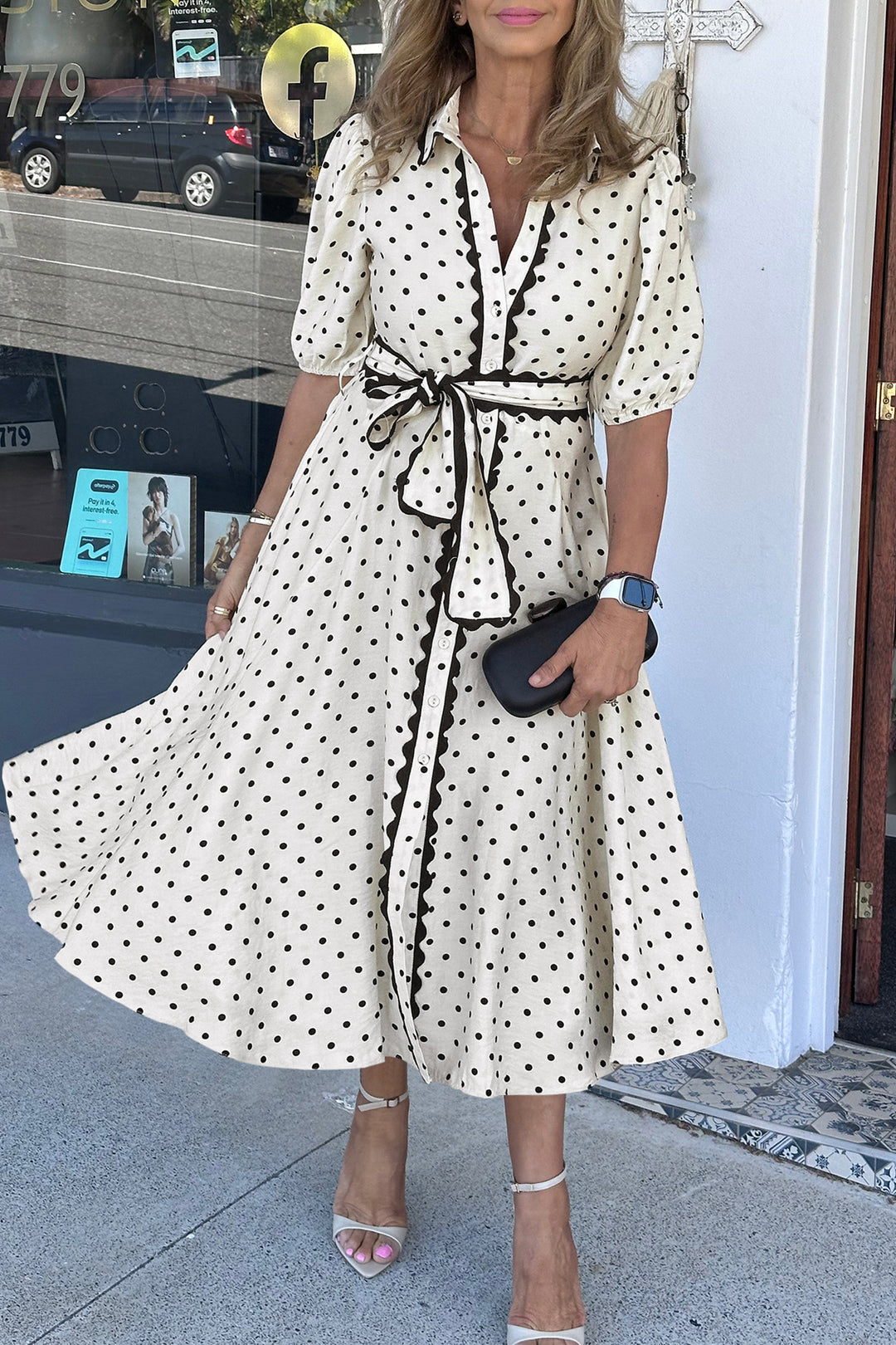 Woman wearing a polka dot dress with a blurred background