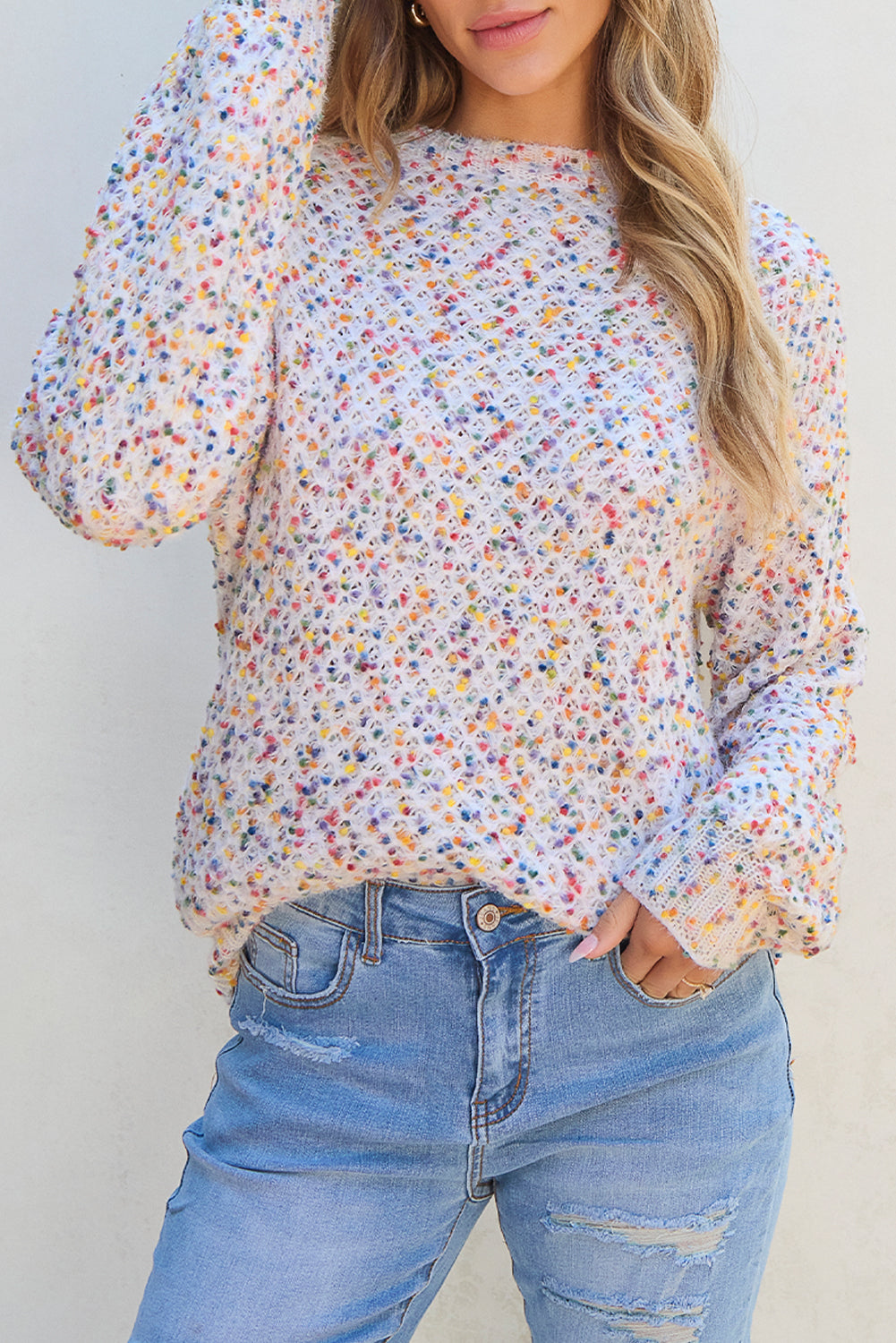 Detailed view of white confetti knit popcorn sweater