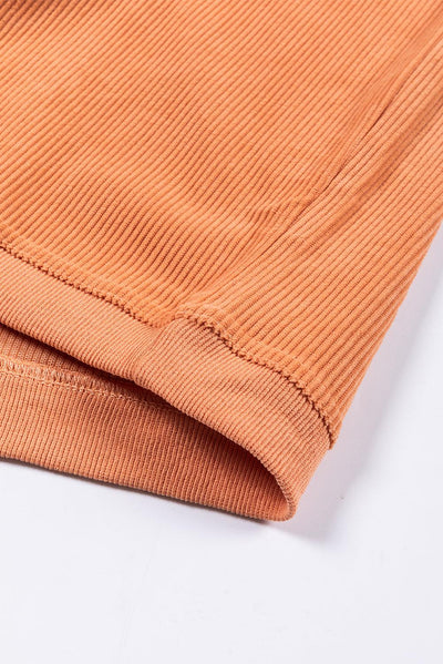 Close-up of ribbed texture on orange sweatshirt