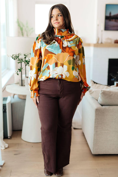 Floral mock neck blouse, styled in a cozy indoor setting.