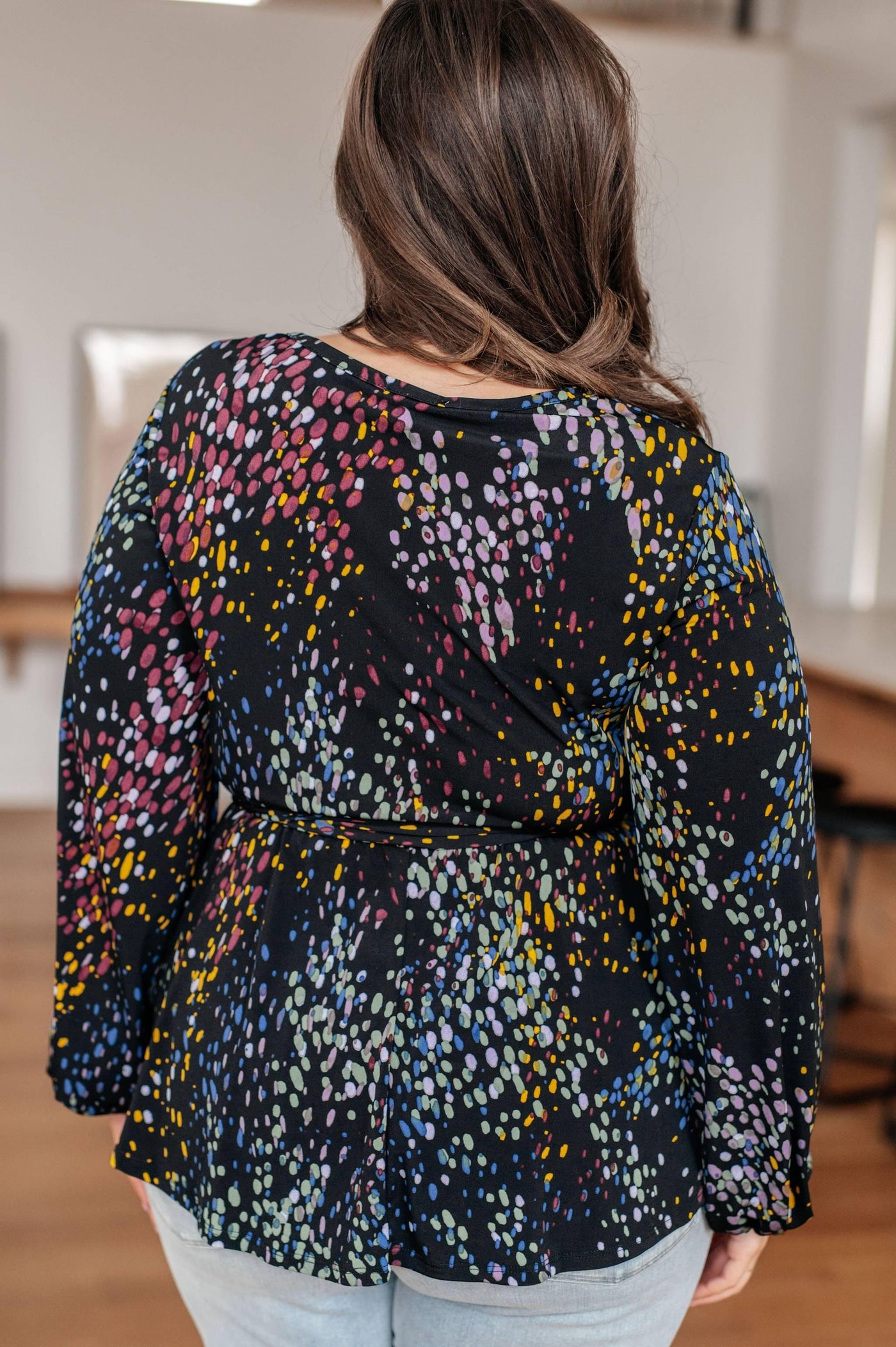 Back view of faux wrap top with colorful print