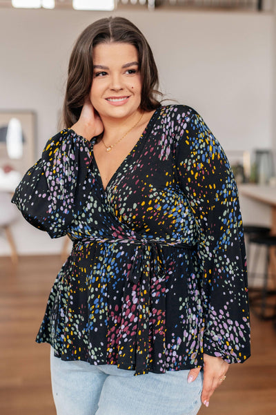 Plus-size model in faux wrap top, side view