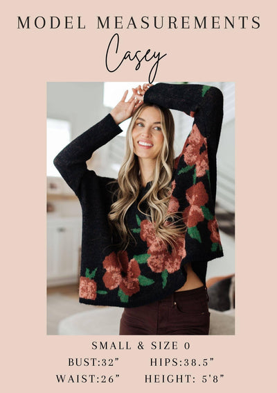 Model Casey's measurements with floral sweater.