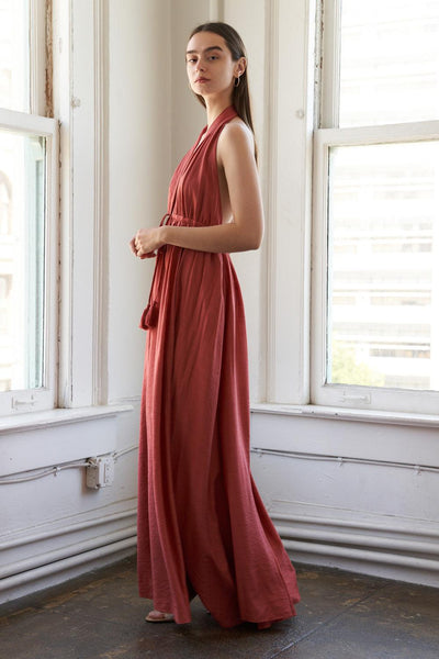 Rust woven maxi dress, side profile, elegant flow.