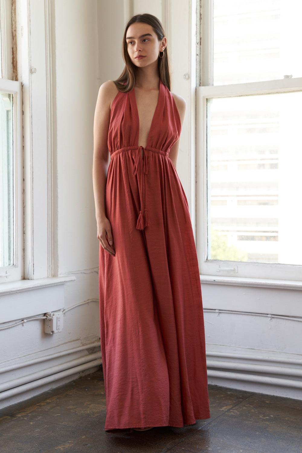 Rust woven maxi dress with deep V-neck, front view.