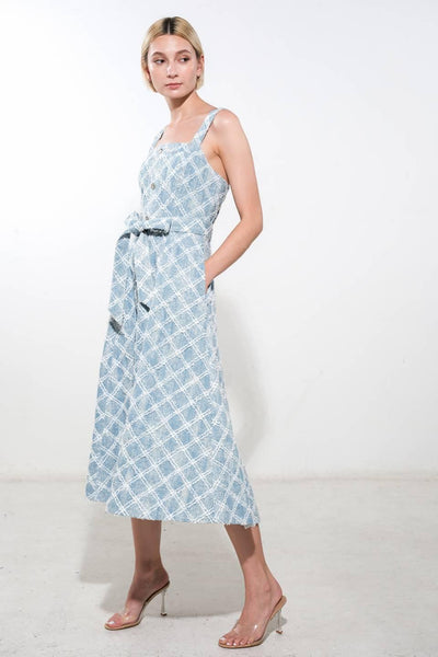 Side profile of light denim midi dress with tie waist.