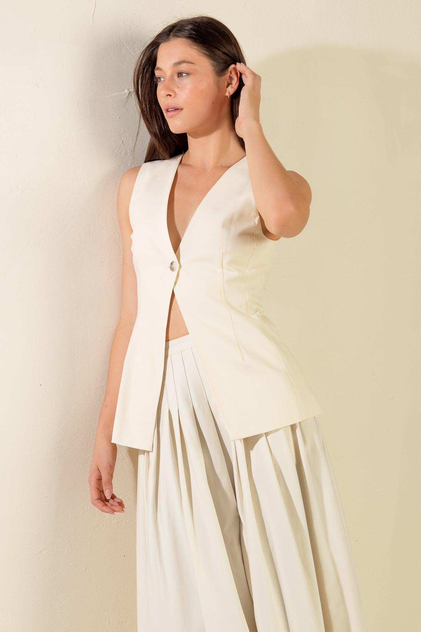 Cream woven vest with pleated skirt outfit