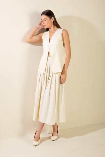 Cream woven vest with pleated skirt ensemble