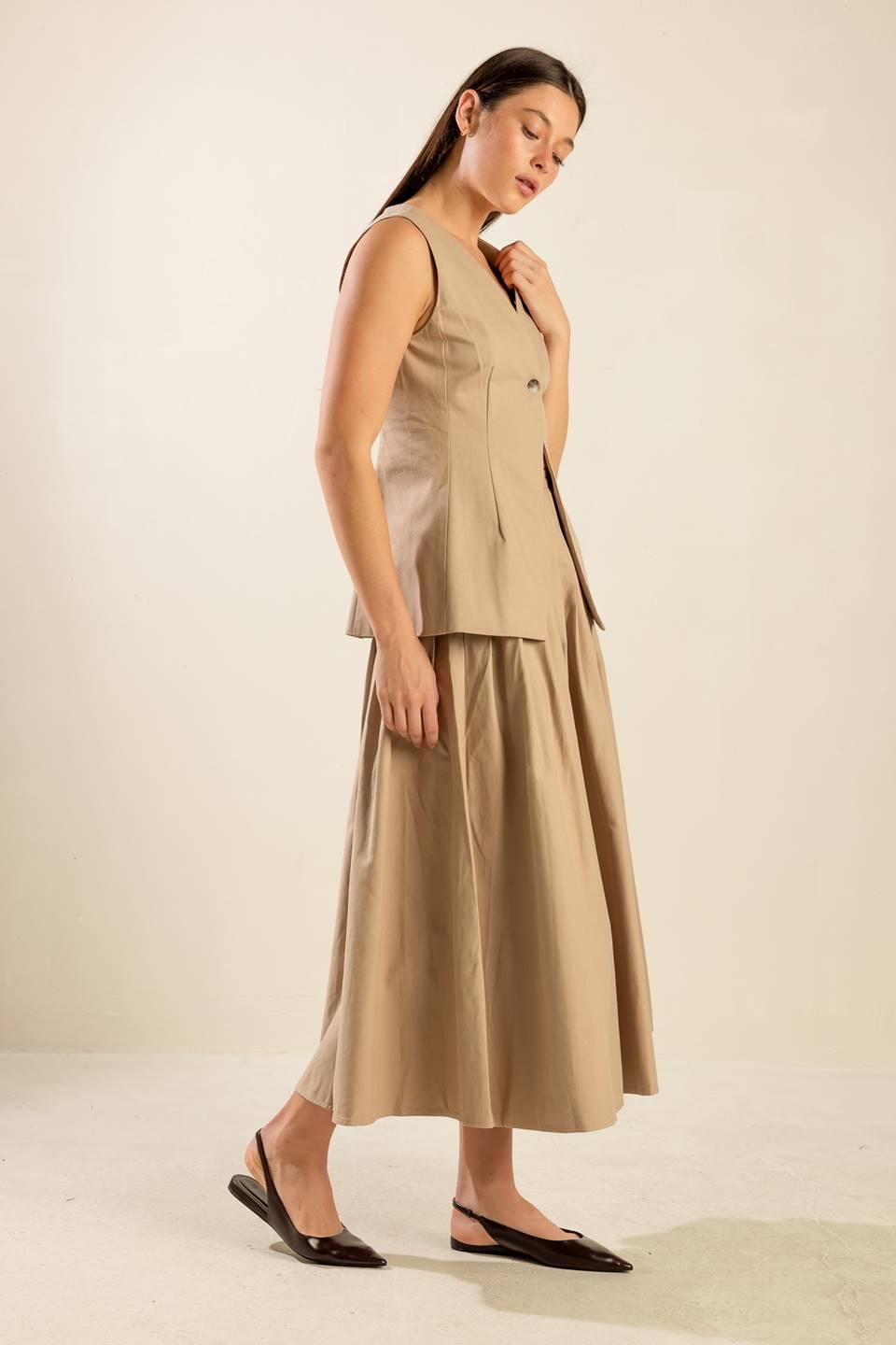 Side view of beige woven vest and skirt