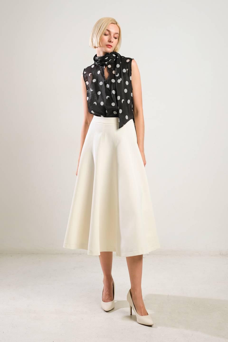 Front view of off-white woven skirt with heels