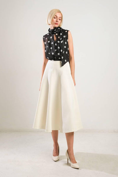 Front view of off-white woven skirt with heels