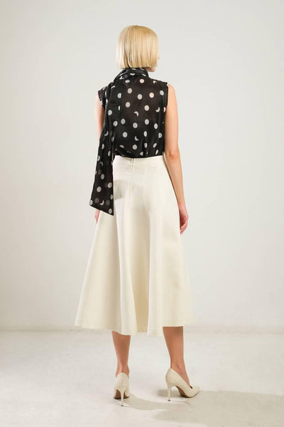 Back view of off-white woven skirt with polka dot top