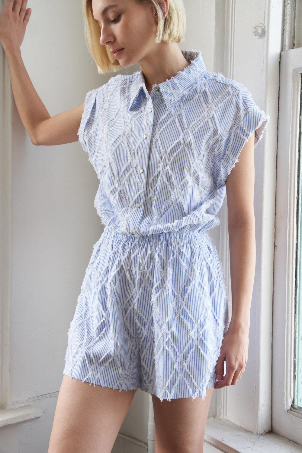 Sky blue woven romper with diamond pattern, side view