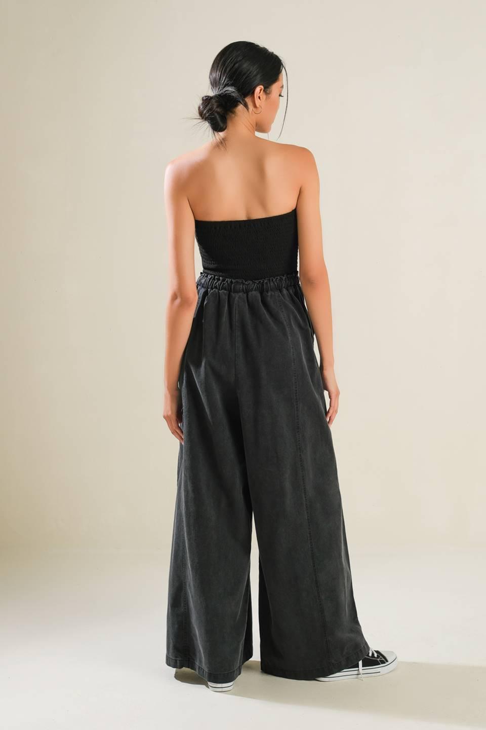 Black strapless jumpsuit with wide-leg pants, back view.