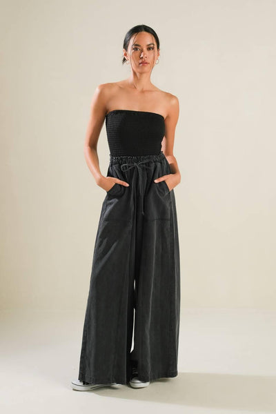 Black strapless jumpsuit with wide-leg pants, front view.