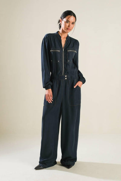 Model wearing navy Horizon Haven woven jumpsuit