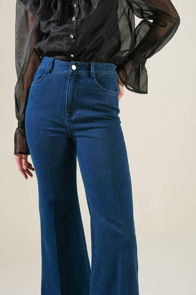 Close-up of front details on denim pants