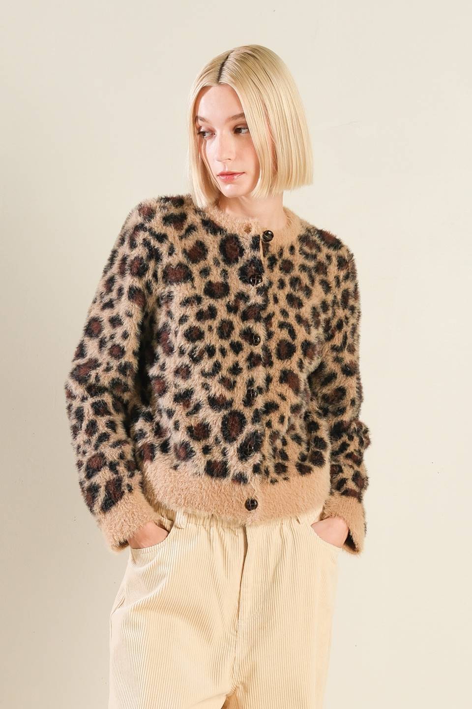 Front view of taupe/black leopard print sweater cardigan