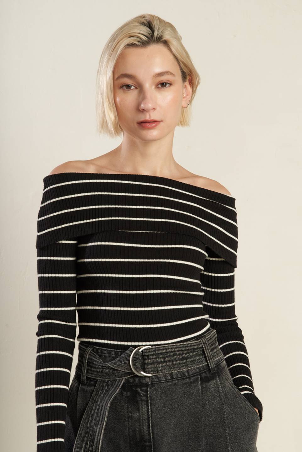 Front view of black and white striped off-shoulder sweater top