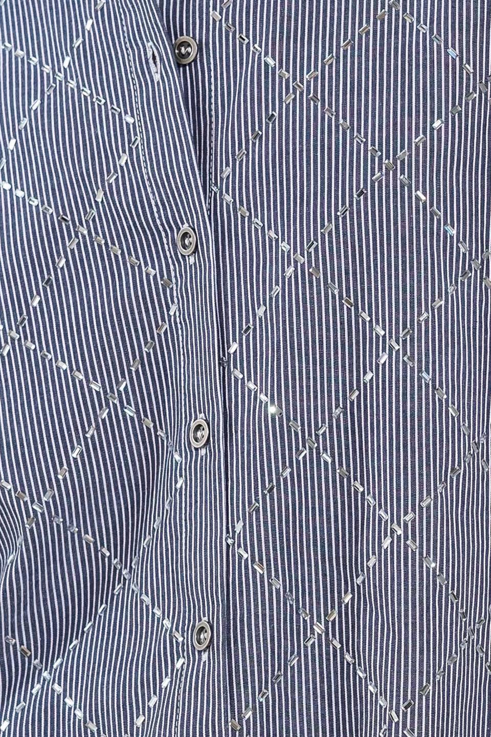 Close-up of navy and white woven top fabric and buttons.