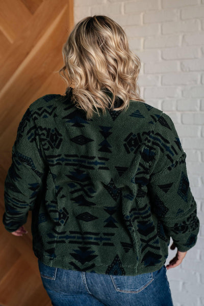 Back view of green geometric fleece jacket on model