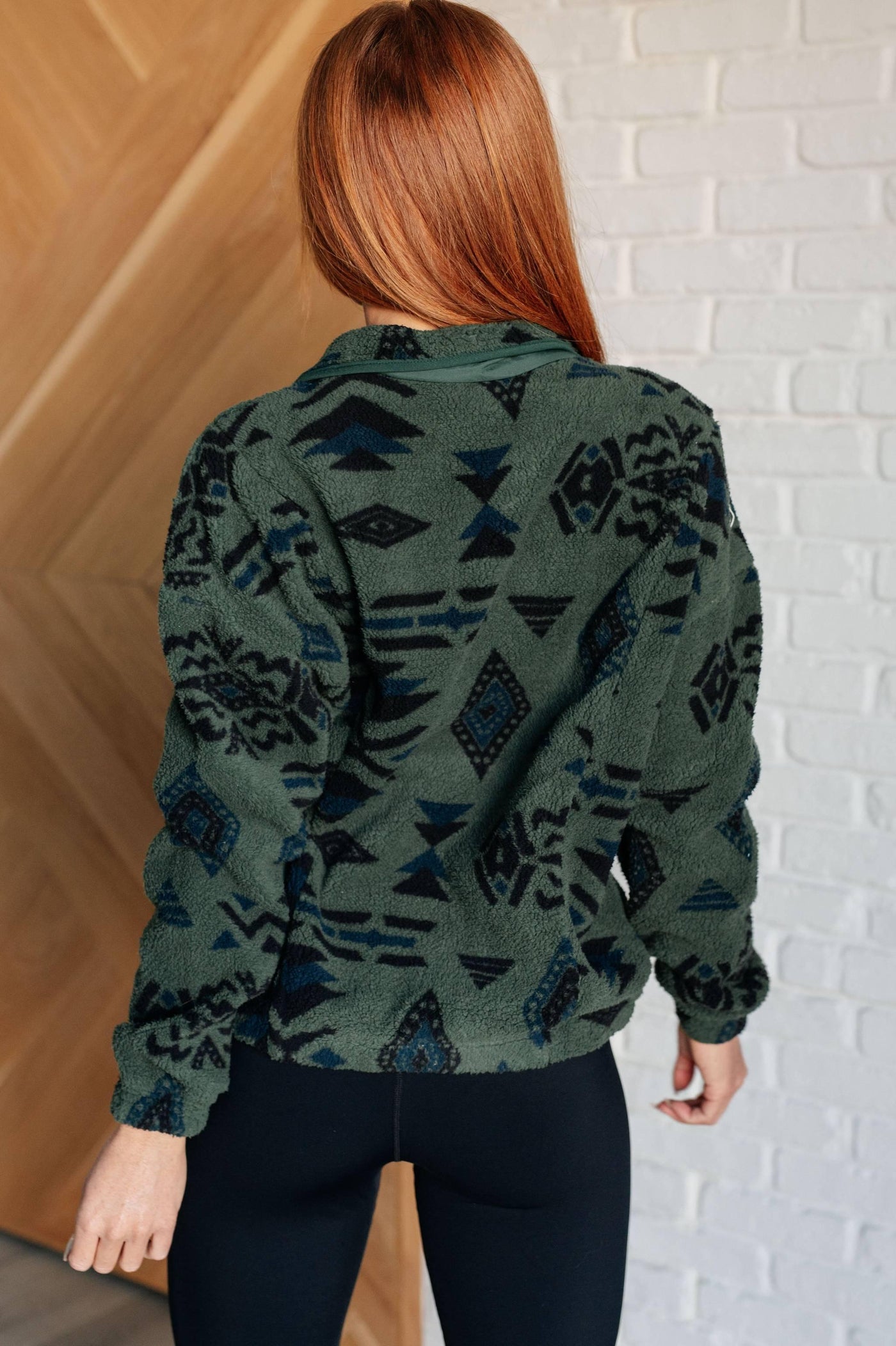 Back view of fleece jacket on red-haired model