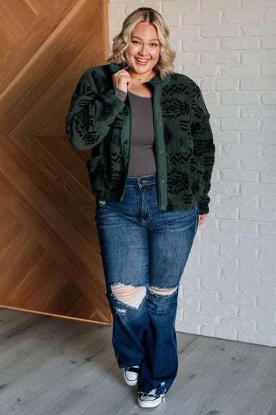 Model in green geometric fleece jacket and jeans