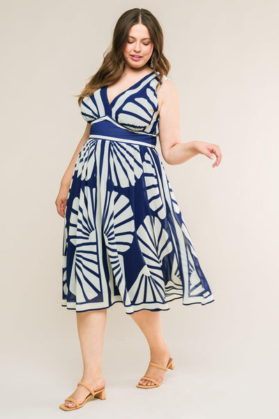 Plus-size model in navy midi dress with bold patterns