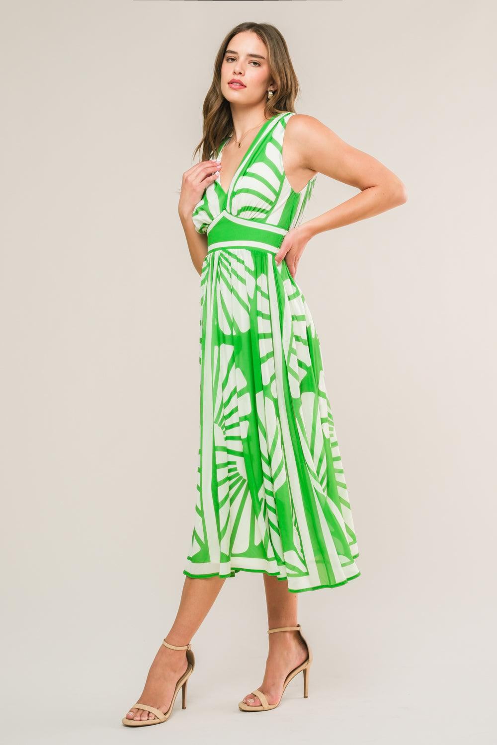 Side view of green woven midi dress with white patterns