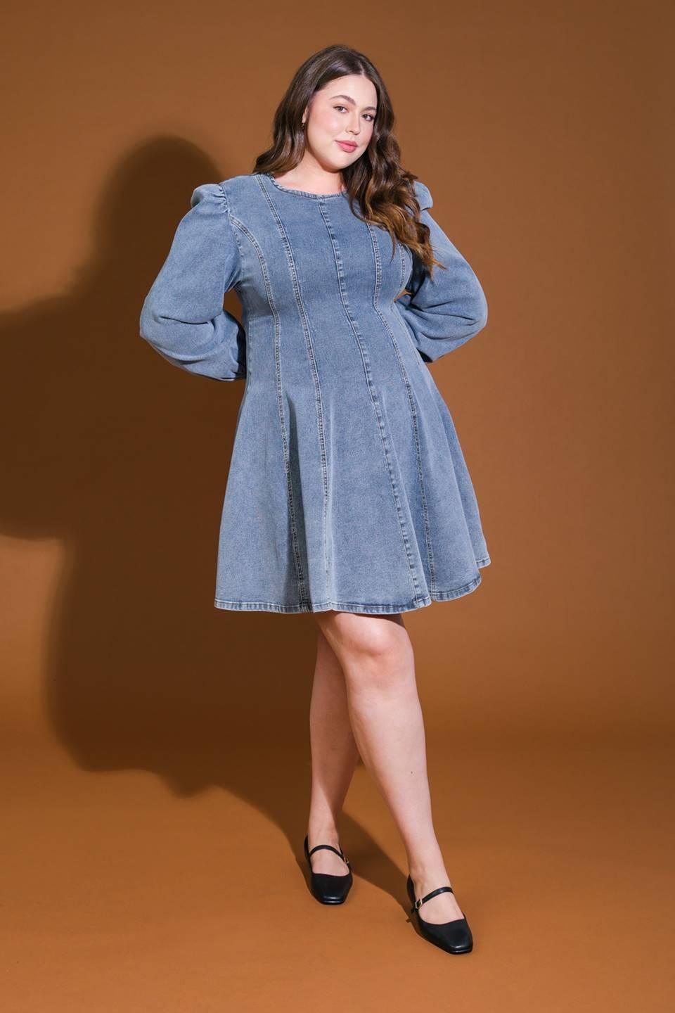 Plus-size model in blue acid wash denim mini dress