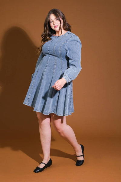 Plus-size model walking in denim mini dress