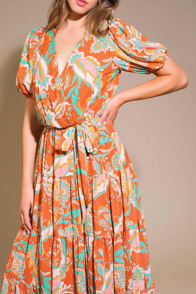 Close-up of rust woven midi dress with floral pattern