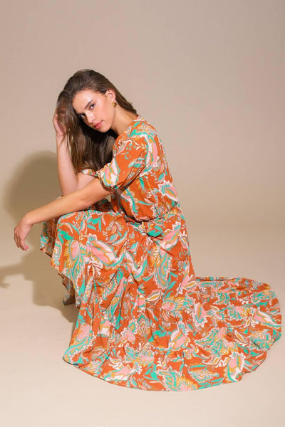 Rust woven midi dress, model seated, floral design