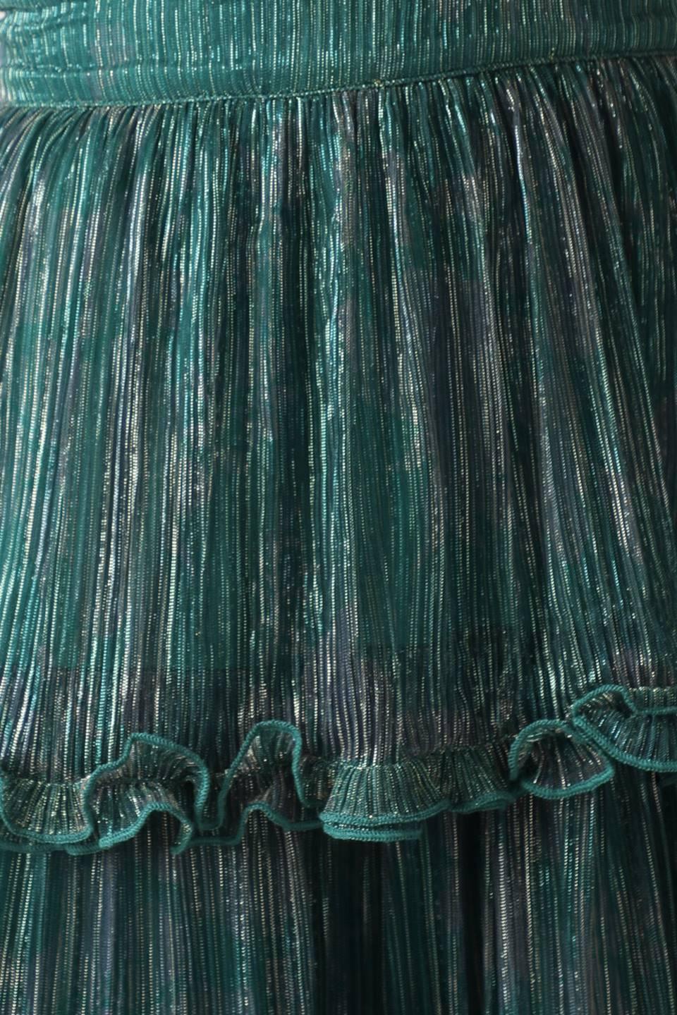 Detail of teal green pleated fabric with ruffles.