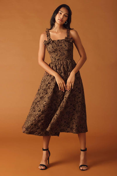 Model wearing brown woven midi dress, floral pattern