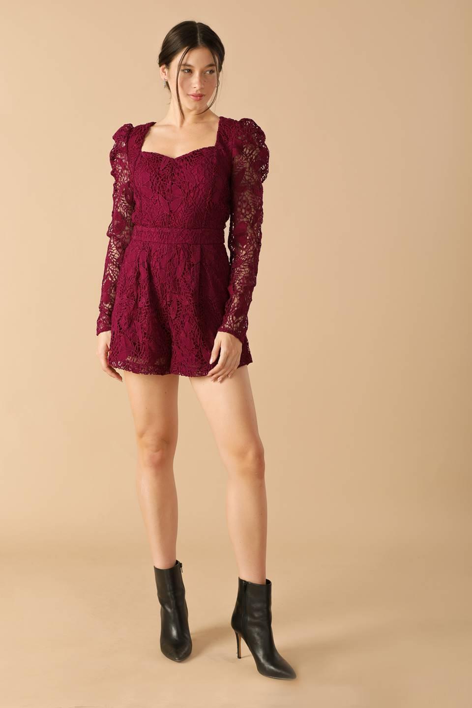 Burgundy lace romper with puff sleeves, side pose.