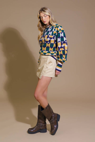 Side view of model in geometric sweater and boots