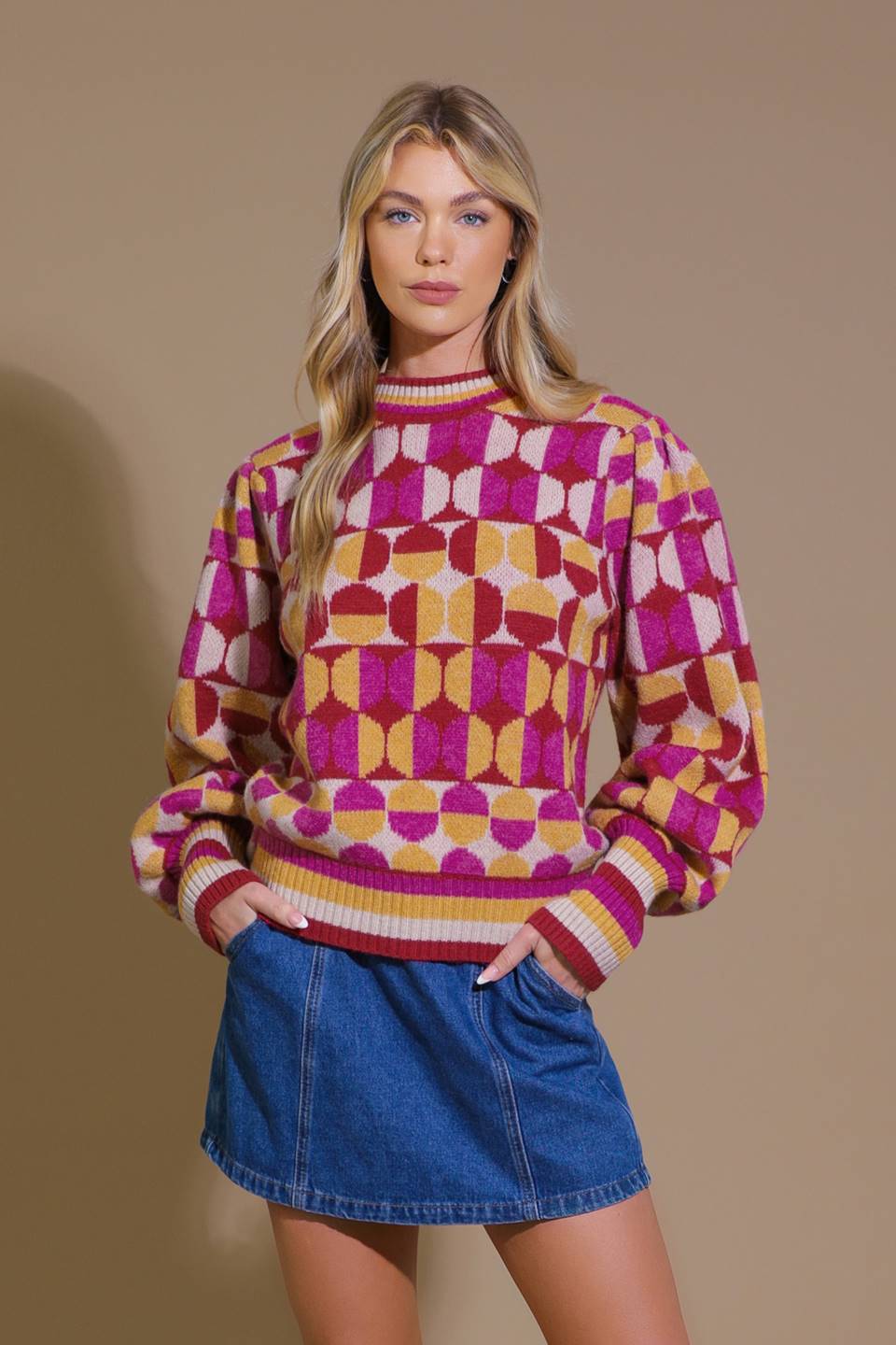 Front view of pink and orange jacquard sweater with denim skirt