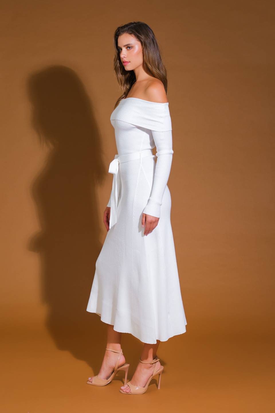 Side view of ivory off-shoulder sweater midi dress