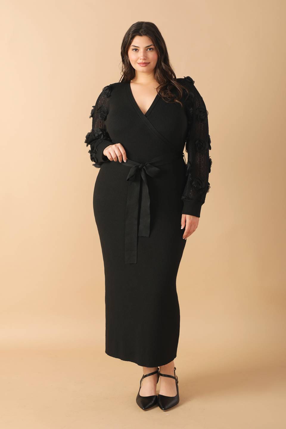 Plus-size model in black sweater midi dress, front view