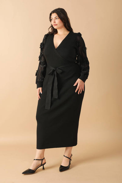 Plus-size model in black sweater midi dress, leaning pose