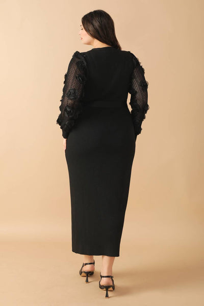 Plus-size model in black sweater midi dress, back view