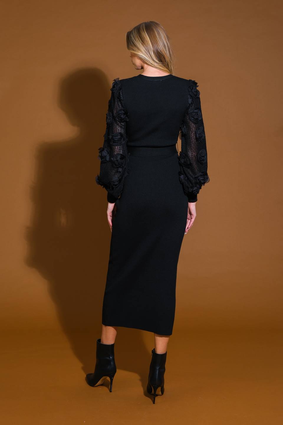 Black sweater midi dress with floral sleeves, back view