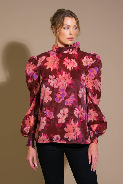 Front view of burgundy floral woven top with puff sleeves